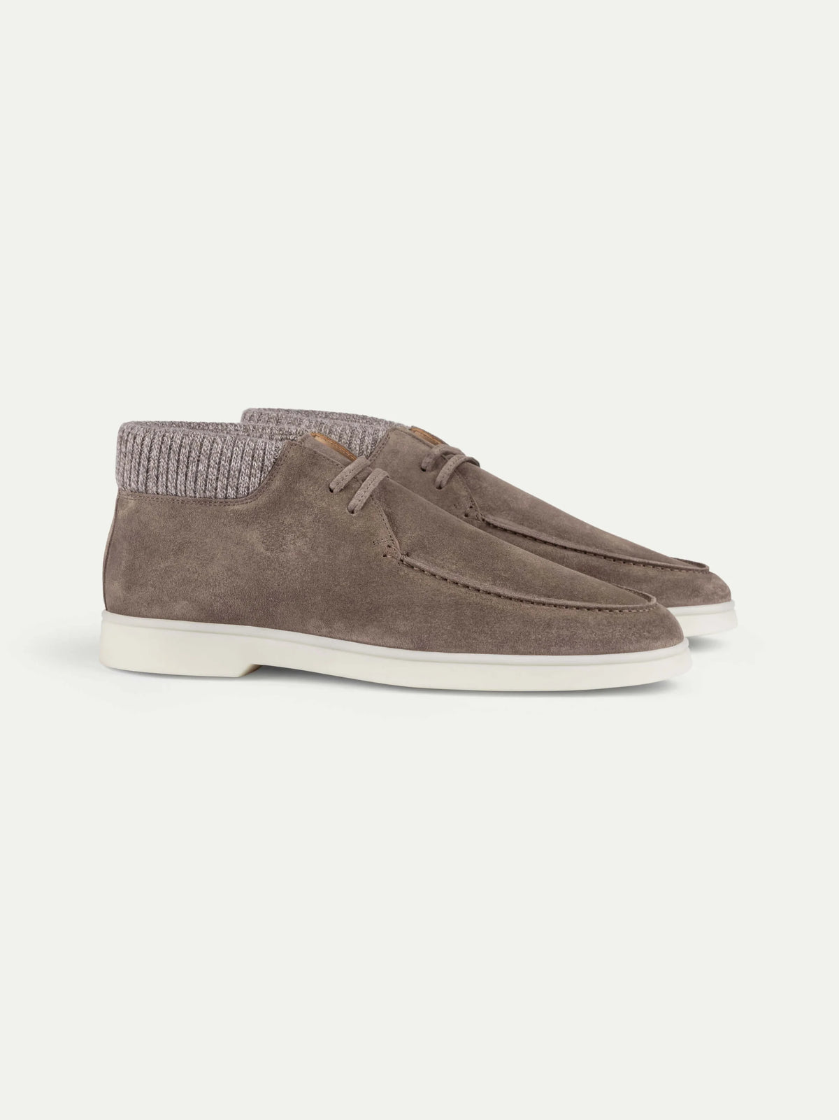 Aurélien Ash Grey Suede Desert Boots with Cashwool Trim feature moccasin-style stitching, white rubber soles, and ribbed knit ankle collars in a matching taupe-gray shade—expertly crafted to highlight Italian craftsmanship. The pair is displayed against a plain white background, with one boot positioned slightly behind the other. , available at Richard Gelding Mayfair