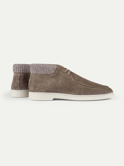 A pair of Aurélien Ash Grey Suede Desert Boots with Cashwool Trim, expertly crafted in Italy from taupe suede with white soles and round toes. These boots showcase a distinctive knit, ribbed collar in light ash grey suede and are presented at a slight angle to highlight both the side and back views against a light background. , available at Richard Gelding Mayfair