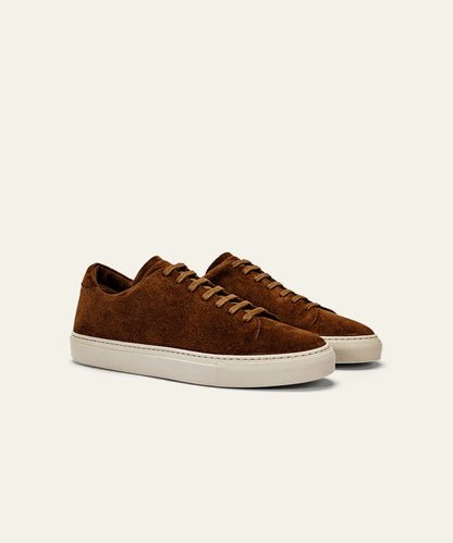 The Azaleri Brown Suede Sneakers Cannaregio feature matching brown laces and white rubber soles, displayed side by side at an angle on a plain light beige background. , available at Richard Gelding Mayfair
