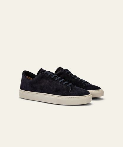 The Azaleri Midnight Blue Suede Sneakers Cannaregio feature matching navy laces and off-white rubber soles, shown angled to display both side and front views against a light beige background. , available at Richard Gelding Mayfair