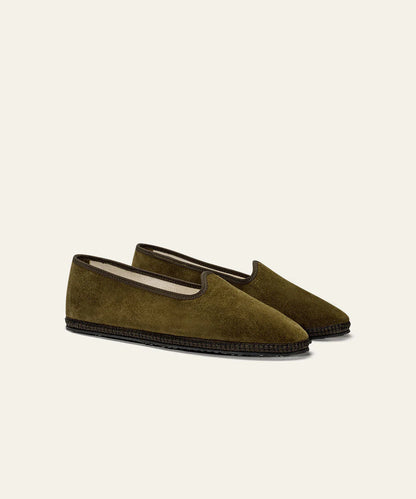 The Azaleri Olive Green Suede Friulane Certosa, featuring black textured soles, low-cut sides, and rounded toes, is displayed side by side on an off-white background, both shoes slightly angled to the right. , available at Richard Gelding Mayfair