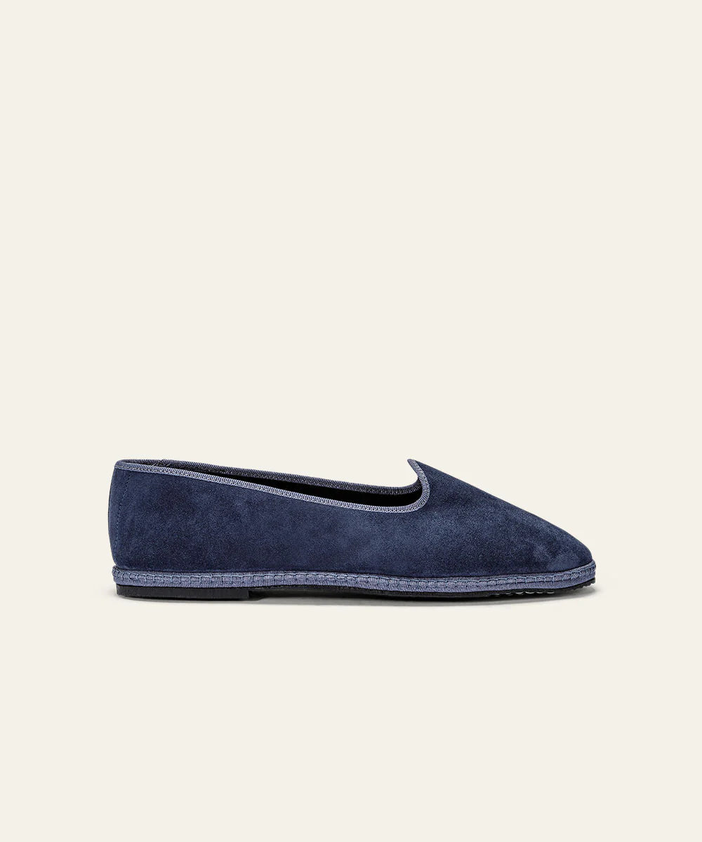 The Space Blue Suede Friulane Certosa by Azaleri is a single navy suede loafer featuring a low heel, rounded toe, and visible sole stitching, shown in profile against an off-white background. , available at Richard Gelding Mayfair