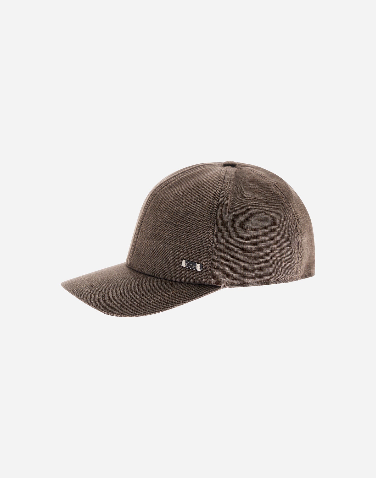 A beige Herno cap, named the Loro Piana Linen Wool Woven Cap, features a curved brim, structured crown, textured linen-wool weave, and a small engraved metal tag above the brim. The background is plain white. , available at Richard Gelding Mayfair