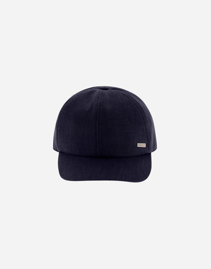The Herno Navy Wool/Silk/Linen Loro Piana Woven Cap features a curved brim, subtle stitching, and a small rectangular metallic tag on the front left side. Set against a solid light gray background. , available at Richard Gelding Mayfair