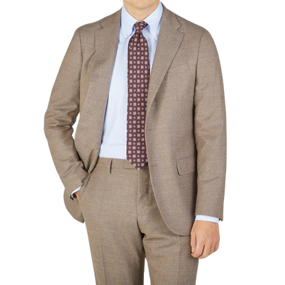 A man is posing in a seasonal Boglioli Beige Grey Wool Flannel K Suit.