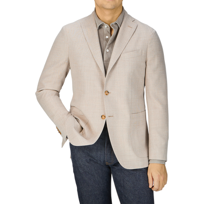 A man in a Boglioli Cream Beige Wool Hopsack K Jacket and jeans showcases unstructured craftsmanship.