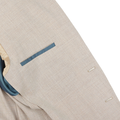 A close up of a Boglioli Cream Beige Wool Hopsack K Jacket suit with a blue pocket showcasing fine craftsmanship.