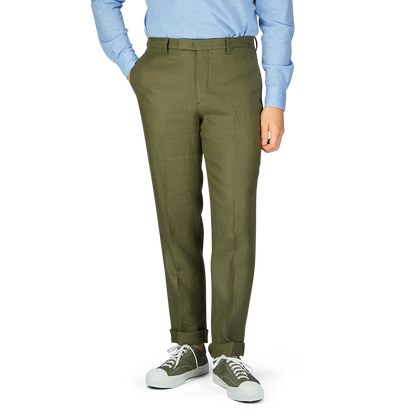 Olive green tapered leg trousers (Green Washed Irish Linen Trousers by Boglioli) paired with casual sneakers and a blue shirt.
