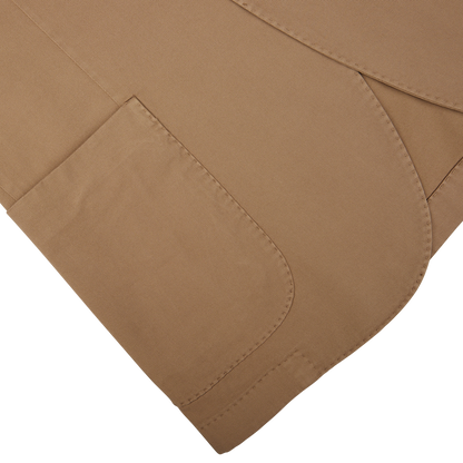 Three overlapping Tobacco Brown Washed Cotton K Jackets with visible stitching on a white background, showcasing unstructured craftsmanship from Boglioli, Italy.