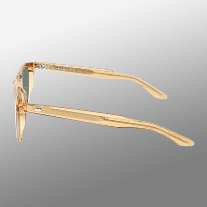 The Carré Eco Champagne | Bottle Green by TBD Eyewear is a pair of transparent, light beige eyeglasses with subtly textured temples, visible hinge area, and slightly yellow-tinted lenses shown from the side on a gray gradient background. , available at Richard Gelding Mayfair