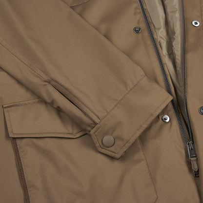 Close-up of the Canali Rust Brown Nylon Four Pocket Field Coat, featuring a zippered front with snap-button flap, snap-button sleeve cuff, large flap pocket, and partially visible smooth weather-resistant lining near the zipper. , available at Richard Gelding Mayfair