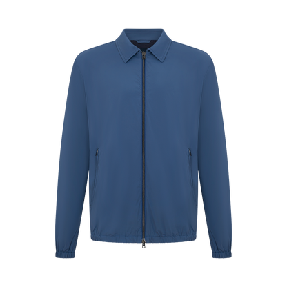 The Herno Blue Lightweight Nylon Zip Jacket features a classic collar, front zipper, side zip pockets, and elastic cuffs and hem. It’s shown from the front on a plain white background. , available at Richard Gelding Mayfair