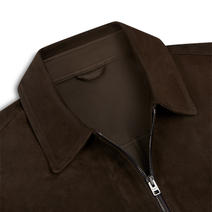 Close-up of the Manto Chocolate Brown Strozzi Zip Suede Blouson, highlighting its pointed collar, soft textured suede finish, and silver zipper partially open to reveal the matching brown lining. , available at Richard Gelding Mayfair