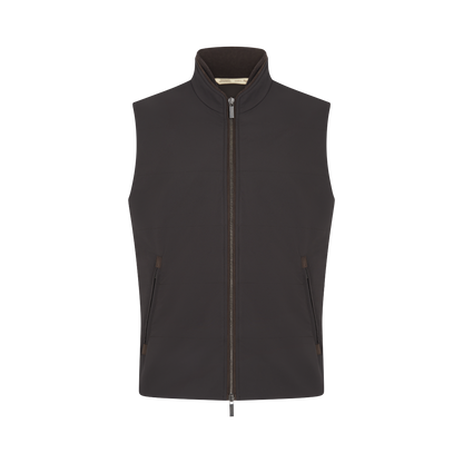 The Maurizio Baldassari Chocolate Brown Nylon Gilet is a men's sleeveless vest with a high collar, two side pockets, visible zippers, and a smooth matte finish—ideal weather-resistant outerwear shown against a white background. , available at Richard Gelding Mayfair