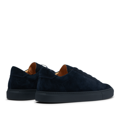 Pair of All Blue Suede Leather Racquet Sr sneakers with brown inner lining on a gradient background by CQP.