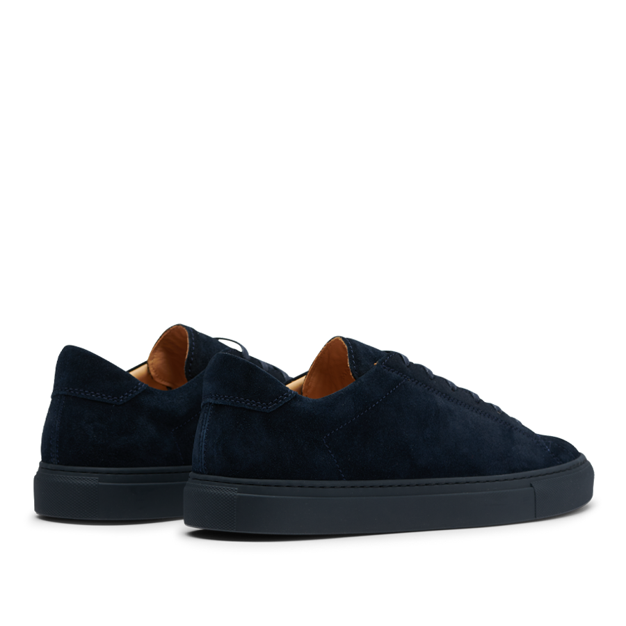 Pair of All Blue Suede Leather Racquet Sr sneakers with brown inner lining on a gradient background by CQP.