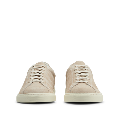 A pair of Beige Suede Leather Racquet Sneakers from CQP, with white laces and a Margom rubber sole, displayed facing forward on a transparent background.