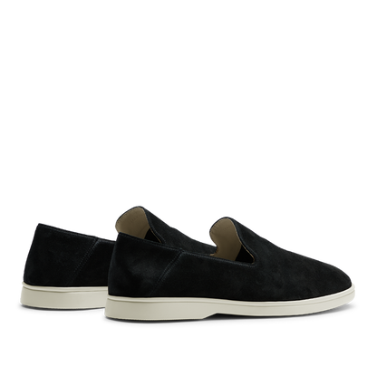 A pair of CQP black suede leather Vice loafers with white soles displayed on a horizontal surface against a striped background.