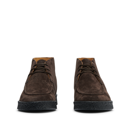 A pair of Chocolate Brown Suede Leather Plana Boots by CQP with black crepe soles viewed from the front, displaying laces tied in bows.