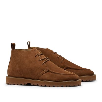 The CQP Snuff Suede Leather Astra Dessert Boots, crafted from brown suede, feature laces and rugged soles that perfectly capture the essence of chukka boots when viewed from the side.