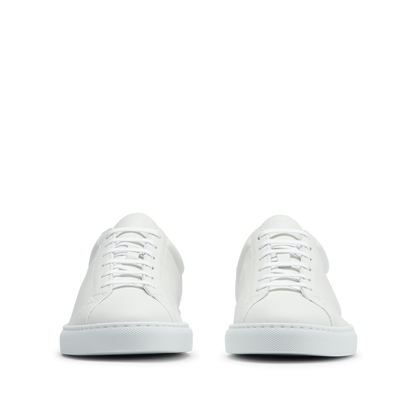 A pair of CQP White Leather Racquet Sneakers on a background.