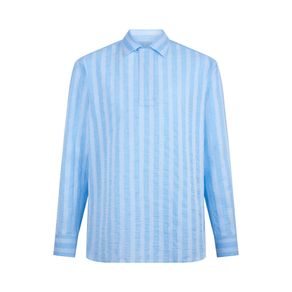 The Alessandro Gherardi Blue Stripe Cotton/Linen Popover Camp Collar Shirt features vertical light blue and white stripes, a relaxed fit, partial front placket, matching striped cuffs, and no visible buttons. , available at Richard Gelding Mayfair