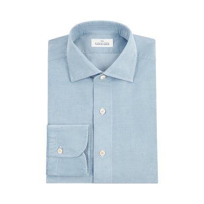 The Alessandro Gherardi Sky Blue Cotton Corduroy Shirt is neatly folded, featuring a pointed collar, white buttons, a single-button cuff, and an inner collar label—all crafted from soft cotton corduroy in Italian style against a white background. , available at Richard Gelding Mayfair