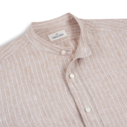 A close-up of the Alessandro Gherardi Brown Stripe Linen Mandarin Collar Shirt, neatly folded to show its white vertical stripes, white buttons, and the brand label inside the collar against a plain white background. , available at Richard Gelding Mayfair