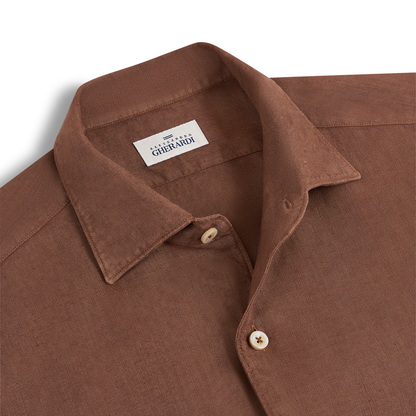 A close-up of the Alessandro Gherardi Tobacco Brown Linen One Piece Collar Casual Shirt, featuring beige buttons and a white label with "Gherardi" in dark blue inside the collar. The textured linen fabric enhances its casual appeal. , available at Richard Gelding Mayfair