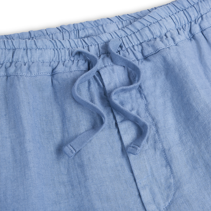 Close-up of the Altea Sugar Packet Blue Linen Drawstring Trouser shows an elastic waistband with center drawstring, visible textured fabric, and a partial right side pocket seam. The style is casual and lightweight. , available at Richard Gelding Mayfair
