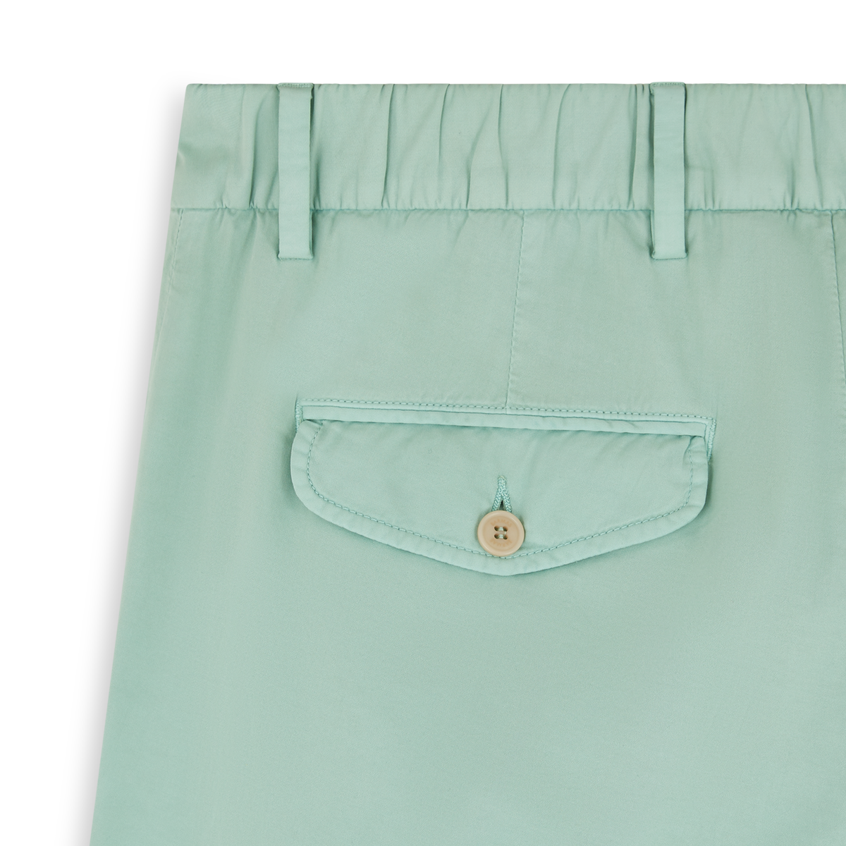 Close-up of Barmas Aqua Green Cotton/Silk Stretch Waistband Chinos, highlighting the elastic waist with belt loops and a back flap pocket secured by a beige button. The smooth, lightweight fabric is featured in the upper section of the pants. , available at Richard Gelding Mayfair