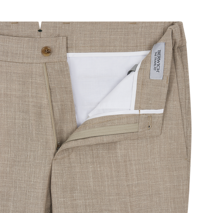 Close-up of the Beige Wool Silk Linen Loro Piana Casual Trouser by Berwich, showing zipper fly, wooden button, visible white pocket lining, inner gray "BERWICH" label on waistband, and detailed fabric texture. , available at Richard Gelding Mayfair