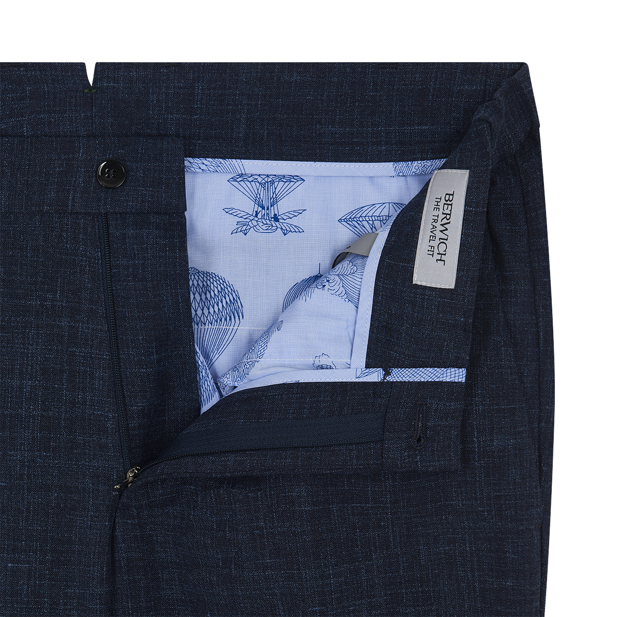 Close-up of Berwich Navy Blue Wool Silk Linen Loro Piana Casual Trouser with open zipper. Light blue hot air balloon and parachute pattern lines the interior. A white tag reads BERWICH THE TRAVEL FIT. , available at Richard Gelding Mayfair