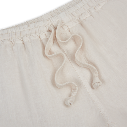 Close-up of Fedeli Off White Linen Drawstring Trousers featuring an elastic waistband, two cream drawstrings tied in simple knots, a soft textured linen fabric, and a vertical seam near the drawstrings. , available at Richard Gelding Mayfair