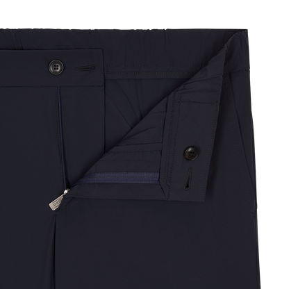 Close-up of Fedeli Navy Blue Bi-Stretch Technical Trousers with open fly and waistband, featuring a zipper, two dark buttons, detailed stitching, and smooth fabric—ideal for comfortable office wear. Shown against a plain white background. , available at Richard Gelding Mayfair