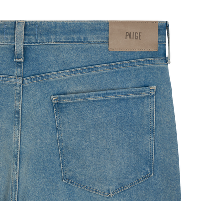 Close-up of the back of Paige Ferdinand Blue Cotton Transcend Normandie Straight Leg Jeans, featuring classic stitching, a single back pocket, and a beige leather waistband patch stamped with the brand name. , available at Richard Gelding Mayfair