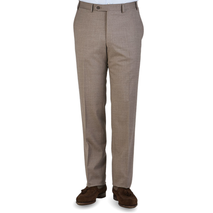 A pair of beige Canali dress trousers displayed without the upper part of the body visible.