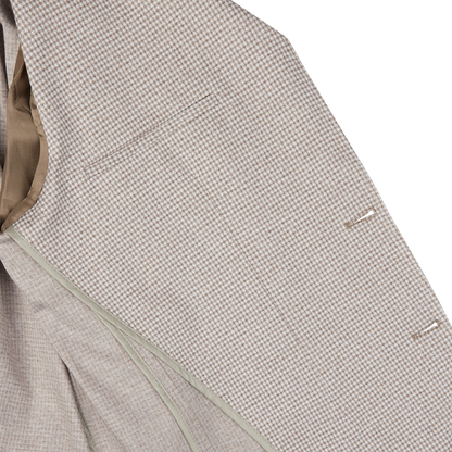 Close-up of a Canali Beige Houndstooth Cotton Jersey Blazer with a houndstooth-patterned suit design and buttons.