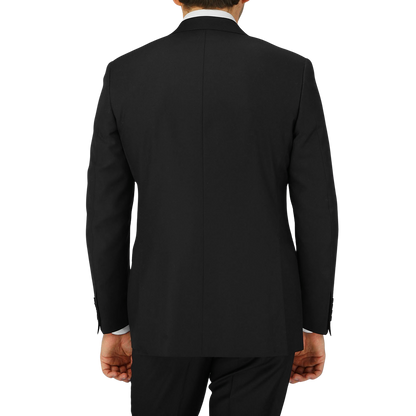 The back view of a man in a timeless Black Virgin Wool Twill Suit by Canali, with a structured shoulder.