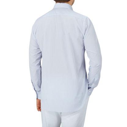 The back view of a Canali-clad man wearing a Blue Mini-Check Cotton Single Cuff Shirt and white pants from Italy.
