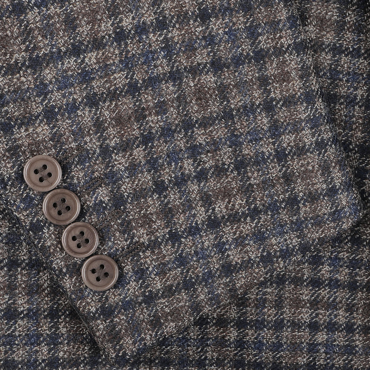 Close-up of a Canali Brown Gunclub Check Wool Drop 6 Blazer sleeve, featuring four dark brown buttons and showcasing its pure wool composition with a classic gunclub check pattern in brown and blue.