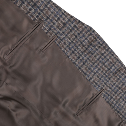 Close-up of the Canali Brown Gunclub Check Wool Drop 6 Blazer showing the interior waistband design with a gunclub check pattern and two vertical pockets. The fabric inside appears as pure wool, brown, and smooth.
