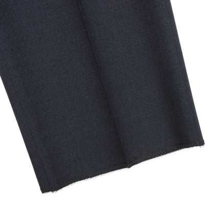 Close-up of Canali's Dark Blue Melange Wool Flat Front Trousers, showcasing the cleanly cut, unhemmed edges against a light gray background.