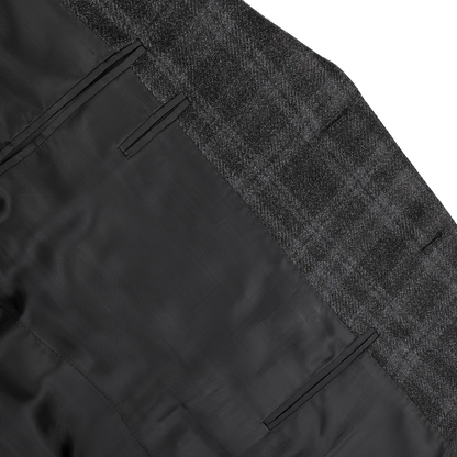 Close-up of the Canali Dark Grey Checked Wool Silk Drop 6 Blazer, featuring black lining and stitching details that embody the Milanese style.