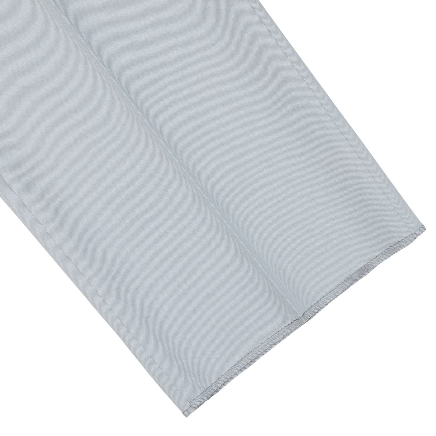 A neatly folded pair of Canali Dove Grey Flat Front Wool Twill Trousers, pale blue with a serged edge.