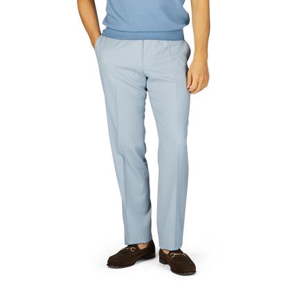 Person wearing Canali Dove Grey Flat Front Wool Twill Trousers and brown shoes standing with hands partially in pockets.