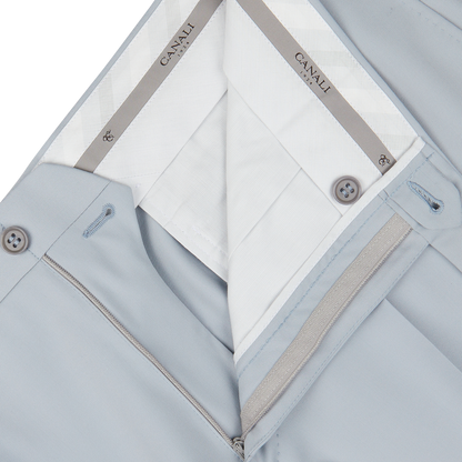 Close-up of a light blue Canali men's jacket made from pure wool twill, with zipper and button details.