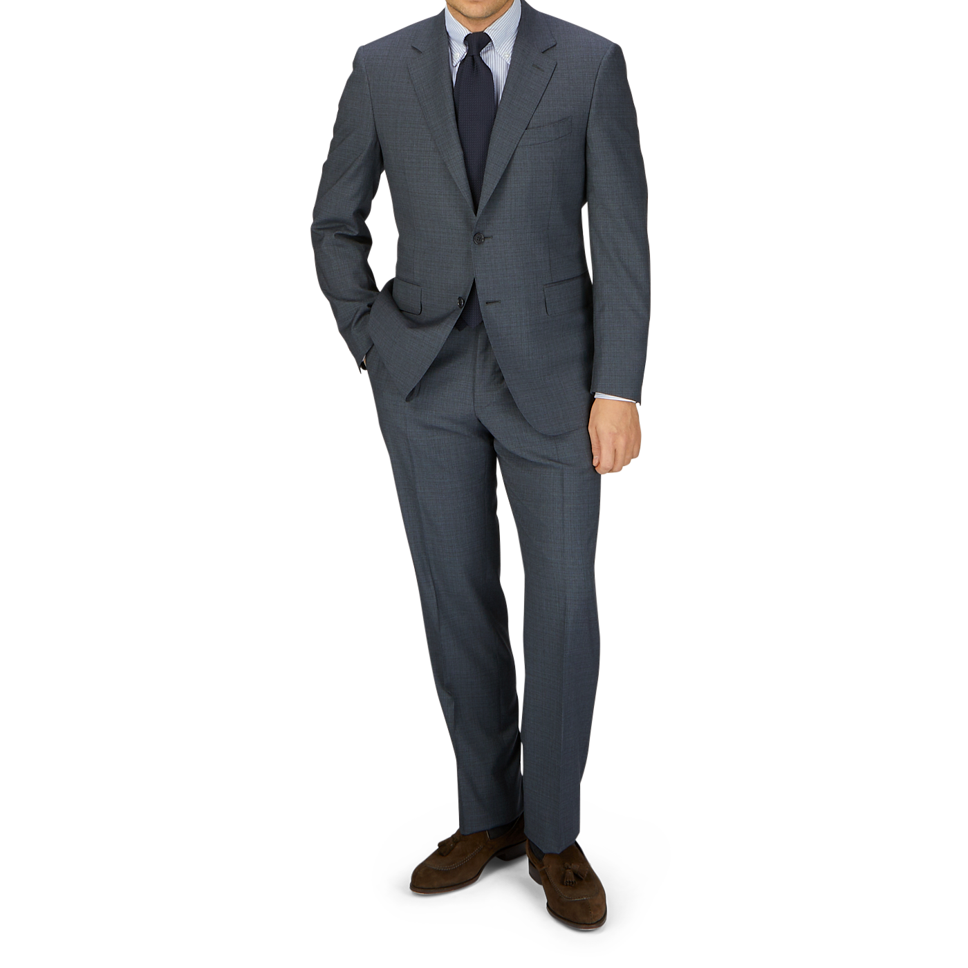 A man in a tailored Canali Grey-Blue Melange Wool Suit, white shirt, and blue tie stands with his left hand in his pocket, against a light gray background.