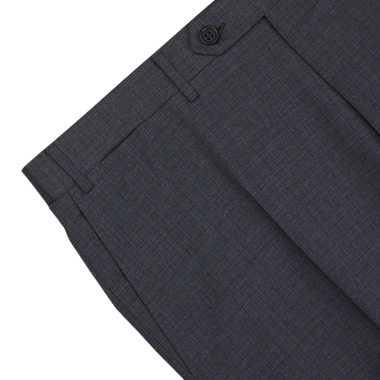 Close-up of a pair of grey-blue Canali suit pants with pockets, displaying a fine check pattern and a single button closure.