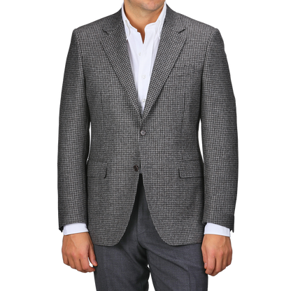 Wearing a Grey Dogtooth Wool Drop 6 Blazer from Canali over a white shirt exudes timeless elegance.